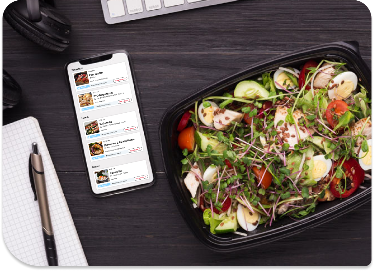 Zerocater app ordering boxed meals on a desk with a salad