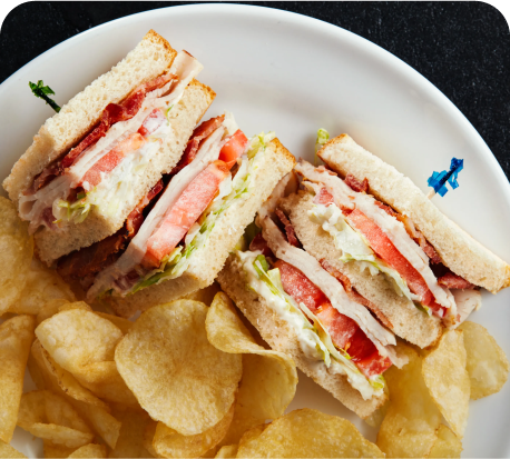 Club sandwich and potato chips on a plate Club sandwich and potato chips on a plate