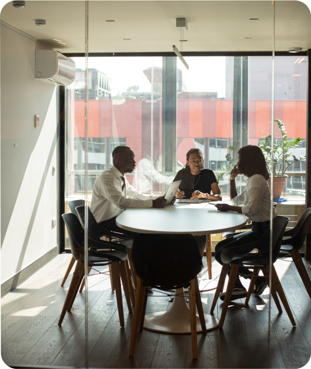 Three employees meeting in an office space Three employees meeting in an office space