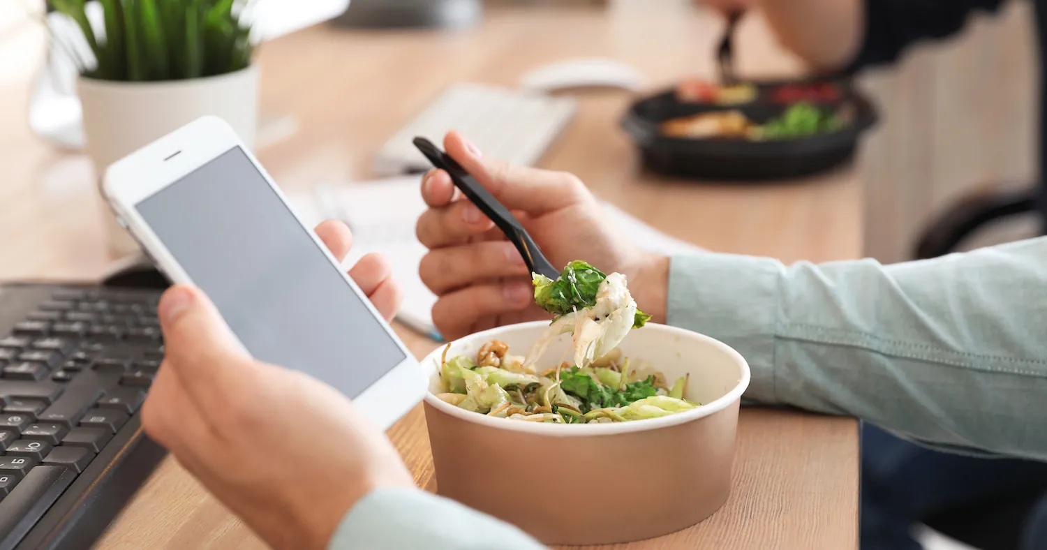 Catered office lunch spread ordered through a mobile app, arranged on a conference room table