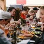 A group of people enjoying a catered meal at a long table in Austin