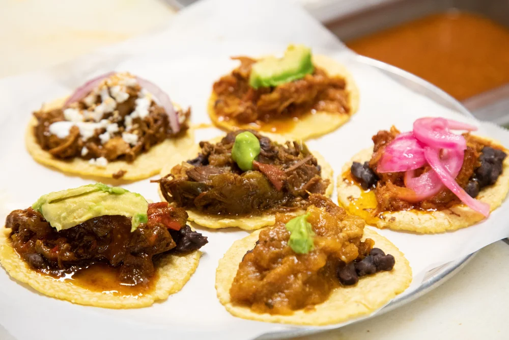 Guisados braised tacos on handmade corn tortillas with salsa verde