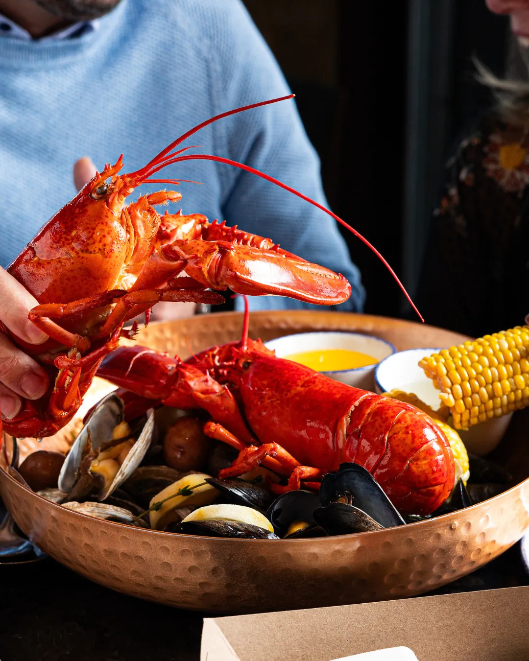 Legal Sea Foods lobster clam bake with corn and shellfish for corporate catering in Boston