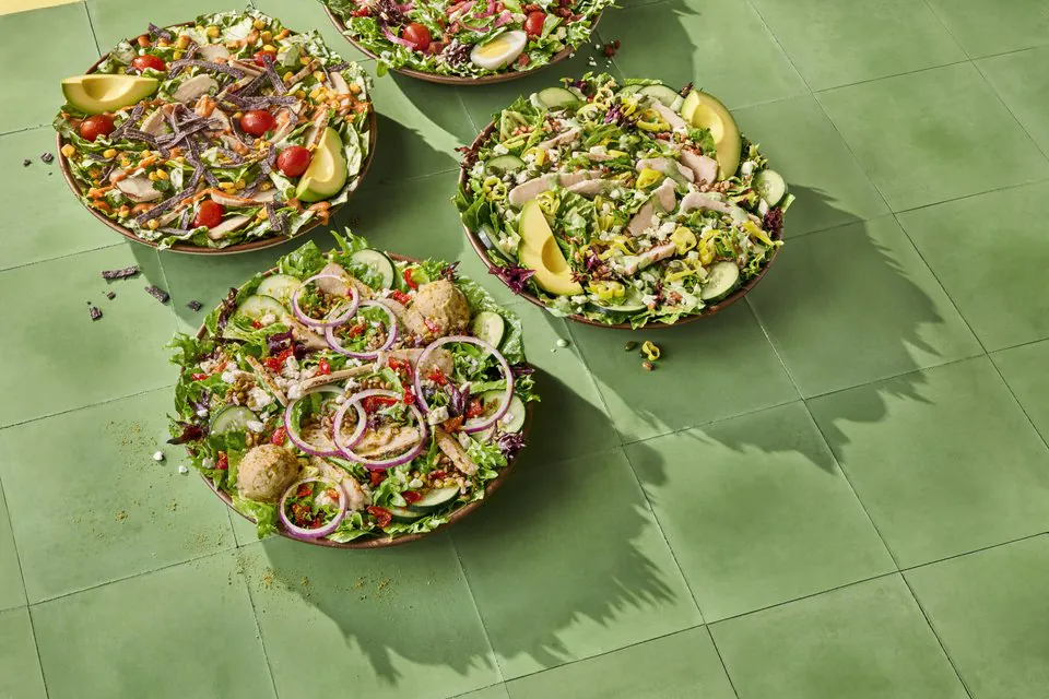 Panera group salad bowls with avocado, tomatoes, onions, and mixed greens for office catering