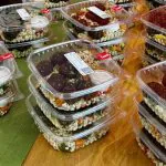 Boxed lunches arranged on a long office table for hybrid team anchor day catering