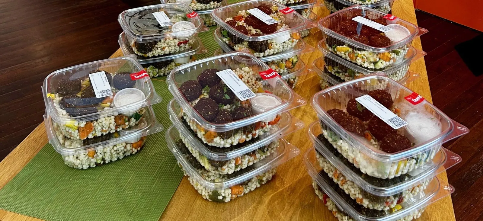 Boxed lunches arranged on a long office table for hybrid team anchor day catering