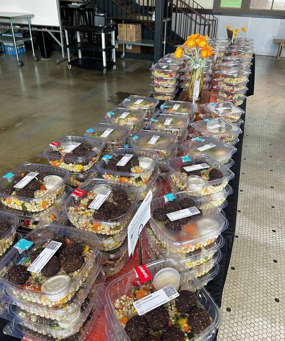 Stacked rows of individually packaged boxed lunches ready for an office meeting