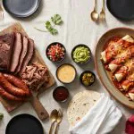 Dallas corporate event catering spread with Texas BBQ brisket, fajitas, and Tex-Mex enchiladas on a banquet table