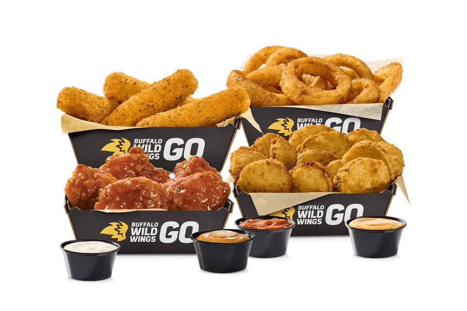 Buffalo Wild Wings catering spread of mozzarella sticks, onion rings, fried pickles, boneless wings and several dipping sauces in branded boxes