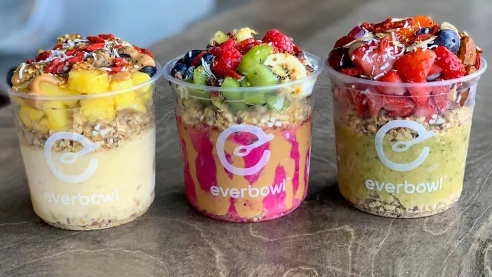 Three Everbowl superfood bowls with acai, pitaya and matcha bases topped with fresh fruit, granola and goji berries