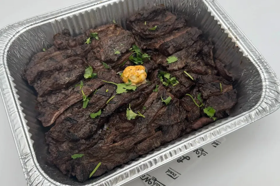 Half pan of Lunch Wired fajita skirt steak topped with fresh cilantro