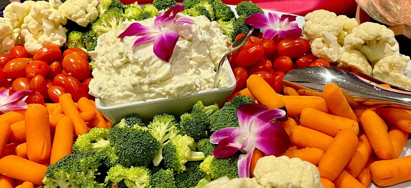 Vibrant fresh vegetable and dip platter, a colorful office catering spread and a fresher alternative to a cold sub tray