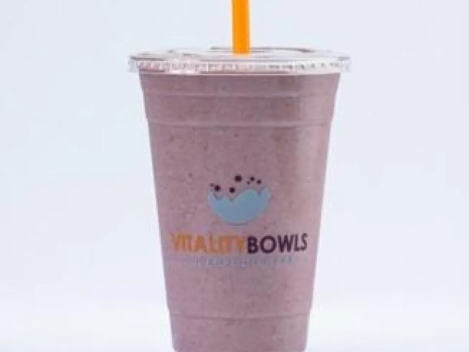 Vitality Bowls branded superfood smoothie cup with a berry-purple smoothie and an orange straw
