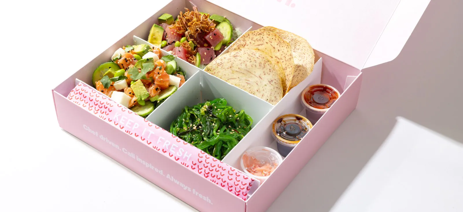 Sweetfin Original Sweetbox catering box with spicy tuna poke, yuzu salmon poke, seaweed salad, taro chips and sauce cups