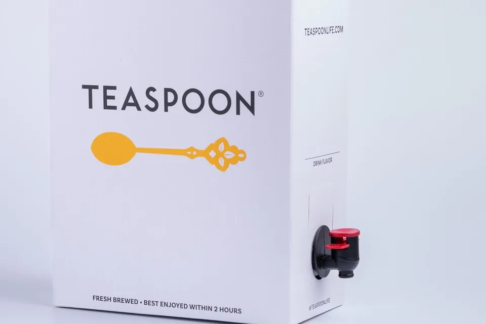 Teaspoon Tea Traveler catering box with the wordmark and spoon logo, a spigot on the side panel, and the printed line FRESH BREWED BEST ENJOYED WITHIN 2 HOURS along the bottom