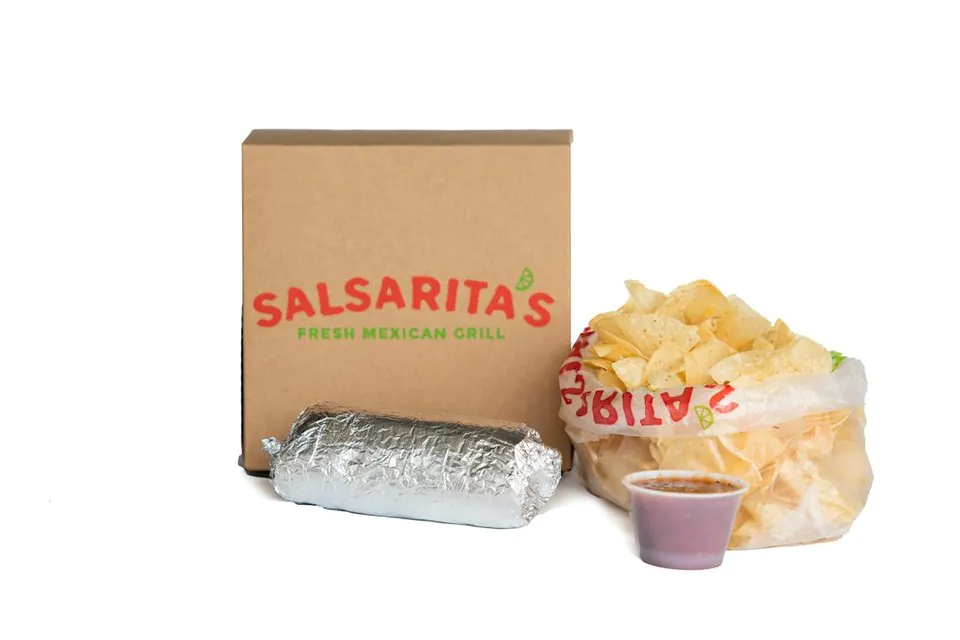 A Salsarita's Burrito Boxed Lunch: a foil-wrapped burrito in front of a kraft box, with a personal bag of tortilla chips and a cup of salsa
